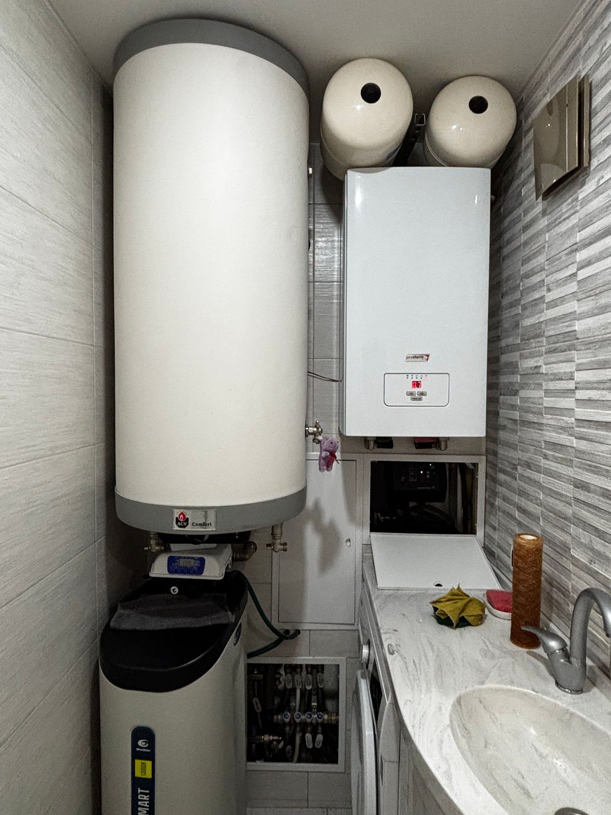 Modern wall-mounted boiler in a domestic utility room